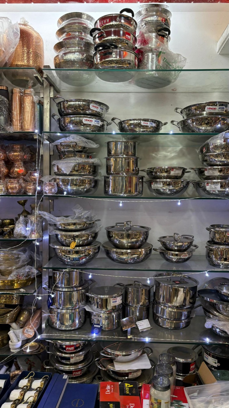 Stainless steel cookware on shelves